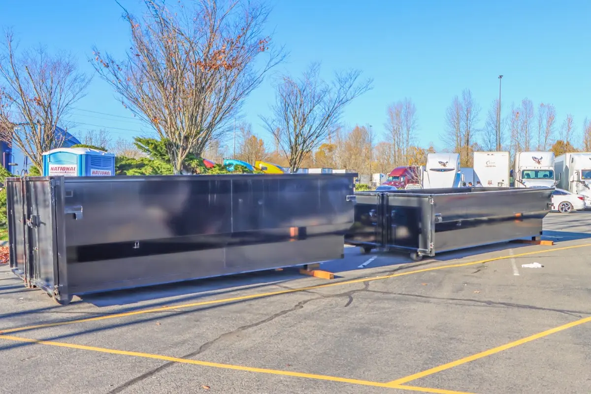 Professional dumpster rental service with roll-off container on residential driveway in Coolbaugh
